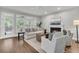 Cozy living room with fireplace, comfortable seating, and large windows offering backyard views at 1436 Lagoon Park Cir, Mount Pleasant, SC 29466