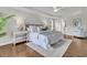 Calm main bedroom boasts tray ceilings, a ceiling fan, hardwood floors and large bed with plush linens and throw pillows at 1436 Lagoon Park Cir, Mount Pleasant, SC 29466