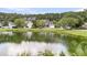 A picturesque pond in the neighborhood reflects the sky, surrounded by lush greenery at 1436 Lagoon Park Cir, Mount Pleasant, SC 29466
