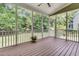 The screened porch has wood floors and a view of the wooded yard at 1436 Lagoon Park Cir, Mount Pleasant, SC 29466