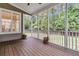 The screened porch features wood floors and a view of the surrounding woods at 1436 Lagoon Park Cir, Mount Pleasant, SC 29466