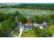 Aerial of bright home with a long driveway and manicured front lawn at 1468 N Relyea Ave, Charleston, SC 29412
