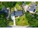 Aerial view of a well-maintained property features a home with a dark roof, lush landscaping and a long driveway at 1468 N Relyea Ave, Charleston, SC 29412