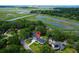 An aerial view of a beautiful home surrounded by lush foliage and waterfront at 1468 N Relyea Ave, Charleston, SC 29412