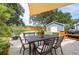 Outdoor dining and BBQ area featuring a large table, chairs, grill, and string lights under a canopy at 1468 N Relyea Ave, Charleston, SC 29412