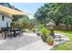 Expansive backyard features a lounging and dining area, lush landscaping, and tranquil outdoor space at 1468 N Relyea Ave, Charleston, SC 29412