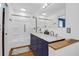 White bathroom featuring double sinks, marble countertops, and a tub shower combo at 1468 N Relyea Ave, Charleston, SC 29412