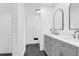 Modern bathroom features double sink vanity, stylish mirrors, and walk-in shower with elegant black tile flooring at 1468 N Relyea Ave, Charleston, SC 29412
