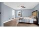 Bedroom featuring hardwood floors, a king sized bed, and access to en-suite bathroom at 1468 N Relyea Ave, Charleston, SC 29412