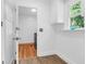 Bright laundry area with white walls, and built in cabinet with a window at 1468 N Relyea Ave, Charleston, SC 29412