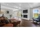 Bright living room features a fireplace, wood floors, and a comfortable brown leather sofa at 1468 N Relyea Ave, Charleston, SC 29412