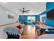 Upstairs living area with wood laminate floors, television, ceiling fan, and an air hockey table at 1468 N Relyea Ave, Charleston, SC 29412