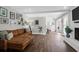 Spacious living room with white ceiling beams, hardwood floors, and a brown leather couch at 1468 N Relyea Ave, Charleston, SC 29412