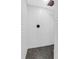 A tiled standing shower featuring black tiled flooring, white subway tiled walls, and bronze fixtures at 1468 N Relyea Ave, Charleston, SC 29412