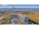 Aerial view of a modern condominium building near a bridge, surrounded by marshland and waterways at 149 Cooper River Dr, Mount Pleasant, SC 29464