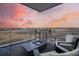 Relaxing balcony with a firepit and gorgeous marsh views under a colorful evening sky at 149 Cooper River Dr, Mount Pleasant, SC 29464