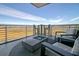 Modern balcony with stylish outdoor seating, a cozy fire pit, and panoramic views of the surrounding marshlands at 149 Cooper River Dr, Mount Pleasant, SC 29464