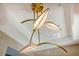 Close-up of a modern chandelier with leaf-like elements, suspended from a ceiling in a stylish home at 149 Cooper River Dr, Mount Pleasant, SC 29464
