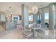 Bright dining area with modern chandelier, seating for four, and large windows providing plenty of natural light at 149 Cooper River Dr, Mount Pleasant, SC 29464