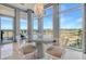 Bright dining area featuring a modern table and chairs, with floor to ceiling windows and marsh views at 149 Cooper River Dr, Mount Pleasant, SC 29464
