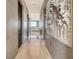 Long hallway with sleek marble floors and modern art pieces, leading to a bright living area at 149 Cooper River Dr, Mount Pleasant, SC 29464