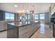 Bright, open-concept kitchen boasts marble counters, a spacious island with seating, and stainless steel appliances at 149 Cooper River Dr, Mount Pleasant, SC 29464