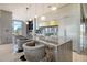 Modern kitchen featuring a marble waterfall island with seating, designer lighting, and stainless appliances at 149 Cooper River Dr, Mount Pleasant, SC 29464