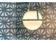Close-up of a contemporary globe pendant light with geometric wallpaper backdrop at 149 Cooper River Dr, Mount Pleasant, SC 29464