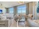 Comfortable living room featuring large windows with scenic views, stylish seating, and neutral color palette at 149 Cooper River Dr, Mount Pleasant, SC 29464