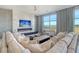 Bright and airy living room with a contemporary fireplace, mounted TV, and expansive windows with breathtaking views at 149 Cooper River Dr, Mount Pleasant, SC 29464