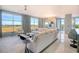 Inviting living room with large windows, comfortable seating, and seamless access to the adjacent kitchen and balcony at 149 Cooper River Dr, Mount Pleasant, SC 29464