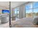 Brightly lit main bedroom featuring a sitting area, TV, and picturesque windows at 149 Cooper River Dr, Mount Pleasant, SC 29464