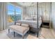 Well-lit main bedroom with a four-poster bed, decorative bench, and expansive windows at 149 Cooper River Dr, Mount Pleasant, SC 29464