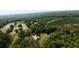 Scenic aerial shot showcasing a property with surrounding farmland, forest, and a tranquil pond at 1613 Cavanaugh Rd, Walterboro, SC 29488