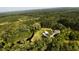 Stunning aerial view of a home nestled amidst lush greenery and surrounded by a serene pond at 1613 Cavanaugh Rd, Walterboro, SC 29488