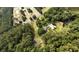 Picturesque aerial view of home on wooded lot with pond and mature trees at 1613 Cavanaugh Rd, Walterboro, SC 29488