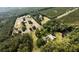 Aerial view highlighting a house near farmland and pond in wooded landscape at 1613 Cavanaugh Rd, Walterboro, SC 29488