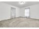 Bright, airy bedroom with neutral carpet, textured ceiling, and sheer curtains creating a serene atmosphere at 1613 Cavanaugh Rd, Walterboro, SC 29488