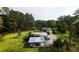 Aerial view of home featuring outbuildings, carports, and mature landscaping at 1613 Cavanaugh Rd, Walterboro, SC 29488