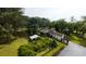 Aerial view of home featuring outbuildings, carports, mature landscaping, and gardens at 1613 Cavanaugh Rd, Walterboro, SC 29488
