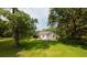 Charming single-story home surrounded by mature trees and lush green lawn at 1613 Cavanaugh Rd, Walterboro, SC 29488