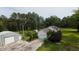 Aerial view of home featuring detached garage, carports, mature landscaping, and gardens at 1613 Cavanaugh Rd, Walterboro, SC 29488