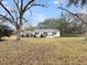 Charming single-story home with a well-maintained lawn and inviting curb appeal, framed by mature trees at 1613 Cavanaugh Rd, Walterboro, SC 29488
