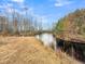 Inviting view of pond surrounded by native grasses and mature trees, inviting quiet reflection at 1613 Cavanaugh Rd, Walterboro, SC 29488