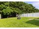 Well-manicured backyard featuring a fire pit and a white privacy fence at 1682 Mermentau St, Mount Pleasant, SC 29466