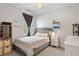 Well-lit bedroom with a queen-size bed, soft carpet, and decor shelving at 1682 Mermentau St, Mount Pleasant, SC 29466