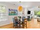 Bright dining area featuring a decorative light fixture, hardwood floors, and views of the living room at 1682 Mermentau St, Mount Pleasant, SC 29466