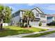 Beautiful two-story home with gray siding, a well-kept lawn, and a mature palm tree in the front yard at 1682 Mermentau St, Mount Pleasant, SC 29466