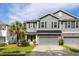 Charming two-story home featuring a gray exterior, well-manicured lawn, and a delightful yellow front door at 1682 Mermentau St, Mount Pleasant, SC 29466