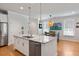 Modern kitchen showcasing a central island with a sink, stainless steel dishwasher, and hardwood floors at 1682 Mermentau St, Mount Pleasant, SC 29466